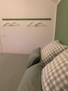 a bedroom with a couch and two hangers on the wall at Das Sommerhaus in Zülow