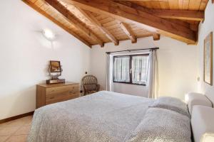 a bedroom with a large bed and a window at Villa Adele in Gravedona +24 photos