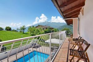 a balcony with a view of a pool and mountains at Villa Adele in Gravedona