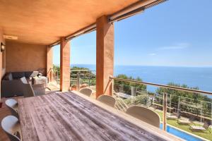 a dining room with a table and a view of the ocean at Casa Marbello - Begur in Begur