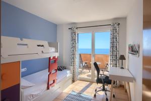 a bedroom with a bunk bed with a view of the ocean at Casa Marbello - Begur in Begur +22 photos
