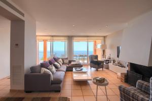a living room with a couch and a table at Casa Marbello - Begur in Begur