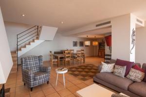 a living room with a couch and chairs and a table at Casa Marbello - Begur in Begur