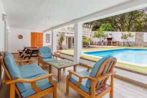 a living room with chairs and a swimming pool at Allotjament Bogues in Lloret de Mar