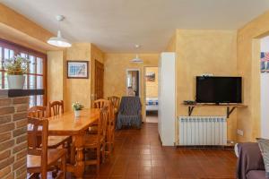a dining room with a table and a television at Allotjament Bogues in Lloret de Mar