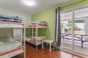 a room with four bunk beds and a balcony at Allotjament Bogues in Lloret de Mar +20 photos