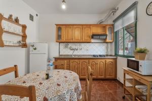 a kitchen with wooden cabinets and a table with a table cloth at Apartamento Nayara C in Valle Gran Rey +15 photos