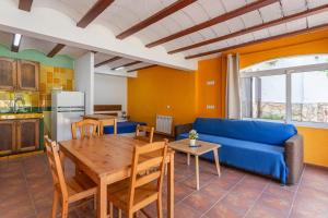 a living room with a blue couch and a table at Allotjament Bogues in Lloret de Mar