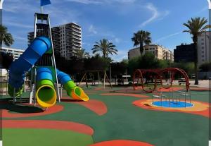 a park with a playground with a slide and slidesktop at Playa Sol Vinaròs in Vinarós