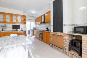a kitchen with a table and a fireplace at Playa Sol Vinaròs in Vinarós