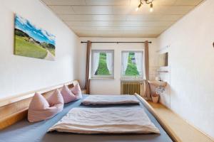 a bedroom with a bed and a window at Ruhbauernhof in Kirchzarten