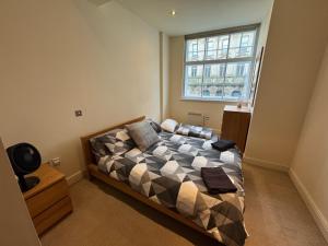 a bedroom with a bed and a window at Cardiff City Escapes in Cardiff +8 photos