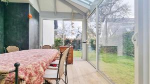 a dining room with a table and a sliding glass door at Albert Ranch House - Grande maison au calme - Parking in Ribeauvillé