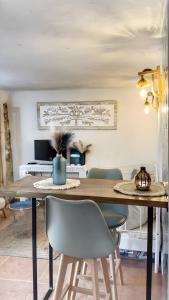 a dining room with a wooden table and chairs at La Casa Arabe in Alcalá de los Gazules