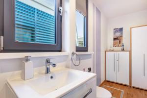 a bathroom with a sink and a window at Hausboot Joana in Zehdenick +18 photos