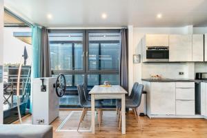 a kitchen and dining room with a table and chairs at Hausboot Joana in Zehdenick