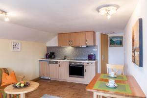 a small kitchen with a table and a dining room at Ferienwohnung Lengdobler - Burgi in Bad Kohlgrub