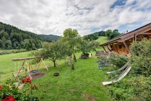 an outdoor yard with swings and a house at Ruhbauernhof in Kirchzarten