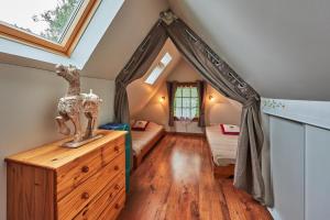 a attic room with a bed and a window at La Cidrerie in Cresseveuille