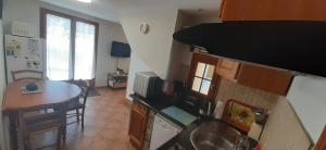 a kitchen with a table and a counter top at La Cidrerie in Cresseveuille