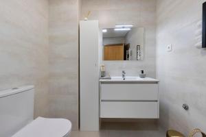 a bathroom with a white toilet and a sink at Vale viver in Vale de Cambra +18 photos