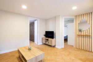 a living room with a tv and a table at Almar in Vigo
