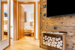 a living room with a flat screen tv on a wall at Wegscheiderhof Apt Gartenwohnung in Velturno