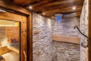 a room with a stone wall with a bed at Wegscheiderhof Apt Gartenwohnung in Velturno +19 photos