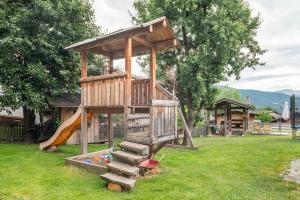 a playground with a tree house and a slide at Wegscheiderhof Apt Gartenwohnung in Velturno