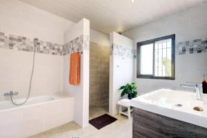 a bathroom with a tub and a sink and a bath tub at Finca Los Pajaros in San Pablo +23 photos