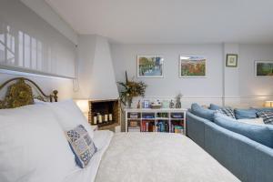 a bedroom with a bed and a blue couch at Host Dalies in Premia de Dalt +22 photos