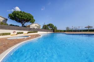 a large swimming pool with blue water at Host Dalies in Premia de Dalt