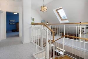 a staircase in a home with a white stair case at Haus Herr Krug in Walkendorf