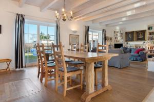 a dining room and living room with a wooden table and chairs at Haus Herr Krug in Walkendorf