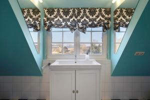 a bathroom with a sink and a window at Haus Herr Krug in Walkendorf +49 photos