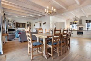 a dining room and kitchen with a table and chairs at Haus Herr Krug in Walkendorf