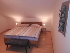 a bedroom with a bed and two lights on the wall at Ferienwohnungen Ambiente-Schmidt in Olsberg