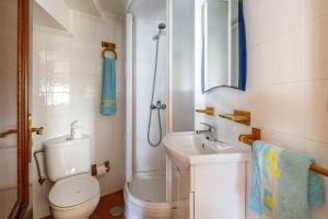a bathroom with a toilet and a sink and a shower at Casa Nueva de Bueu in Bueu +30 photos