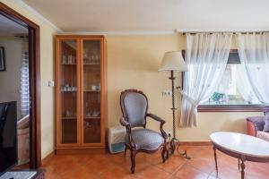a living room with a chair and a table at Casa Nueva de Bueu in Bueu