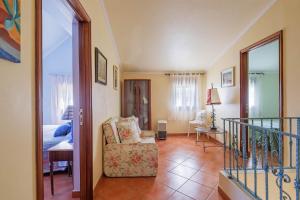 a living room with a chair and a balcony at Casa Nueva de Bueu in Bueu