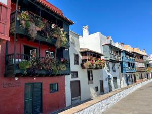 a row of buildings with flower boxes on their windows at Salitre Tea in Los Cancajos