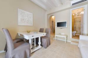 a living room with a white table and chairs at Dalt Vila House in Ibiza Town