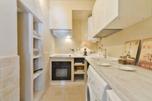 a kitchen with a sink and a stove top oven at Dalt Vila House in Ibiza Town