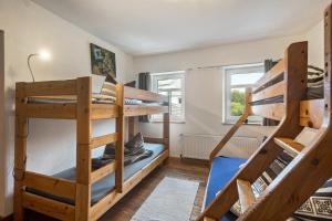 a bedroom with two bunk beds in a room at Ferienhaus Eifellandhaus in Zweifelscheid