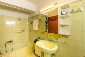 a bathroom with a sink and a bath tub at Serenity Paxos in Gaios +17 photos