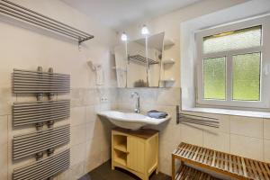 a bathroom with a sink and a window at Ferienhaus Eifellandhaus in Zweifelscheid +33 photos