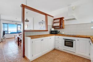 a kitchen with white cabinets and a counter top at Casa Vivo in Famara