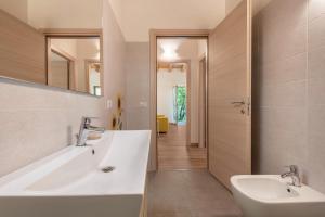 a bathroom with a tub and a sink and a mirror at Nonno Bigi Girasole in Tremosine Sul Garda +28 photos