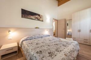 a bedroom with a large bed and a cabinet at Nonno Bigi Girasole in Tremosine Sul Garda