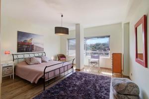 a bedroom with a bed and a large window at Villa Rosana in Albufeira +19 photos